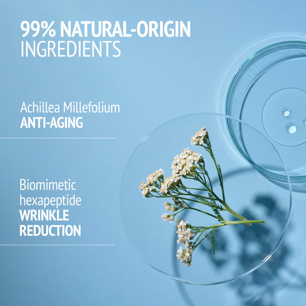 Close-up of delicate white flowers on a clear petri dish alongside another empty dish on a light blue background, highlighting 99% natural-origin ingredients in Sublime Skin Intensive Serum | [ comfort zone ] for skincare and anti-aging benefits.
