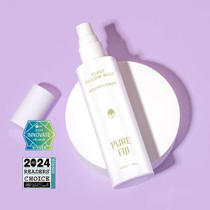 White spray bottle of Pillow Mist | Pure Fiji with awards displayed on a lavender background, suggesting a calming and luxurious wellness product for skincare and sleep care.