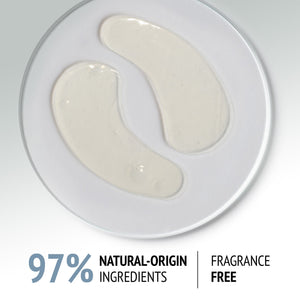 Clear gel eye patches shaped to fit under the eyes, displayed on a white plate, promoting skincare with Sublime Skin Eye Patch | [ comfort zone ] featuring 97% natural-origin ingredients and fragrance free.