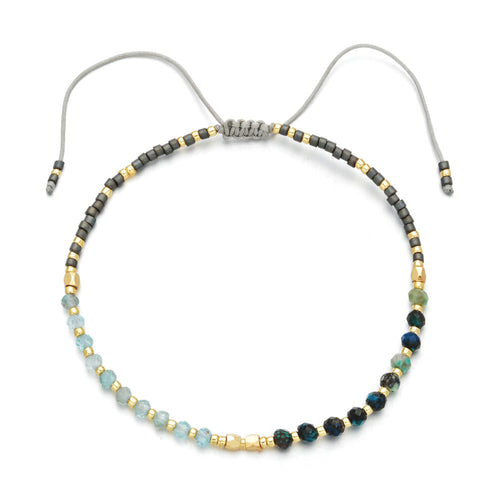 Japanese Handmade Bead Bracelets | Live Love Spa featuring a delicate mix of light blue, green, and dark beads with gold accents on an adjustable gray cord, symbolizing wellness and style.