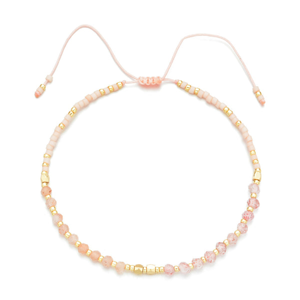 Delicate light pink and gold beaded bracelet with adjustable closure, showcasing craftsmanship in Japanese Handmade Bead Bracelets | Live Love Spa.