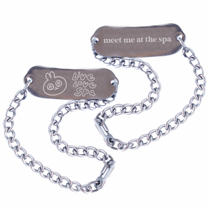 Reversible Engraved ID Bracelet (unisex) - Cute Spa Bunny | Lucky Owl featuring a silver chain with one side engraved with a bunny and "Live Love Spa" and the other side engraved with "meet me at the spa" text.