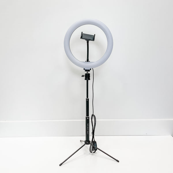 Ring Light - 10" standing on a black tripod with adjustable height and a phone holder in the center, suitable for skincare and wellness content creation.