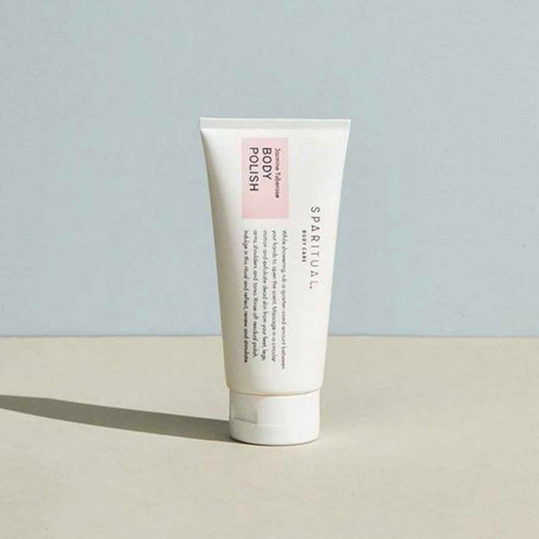 Tube of Jasmine Tuberose BODY POLISH | Sparitual skincare product standing on a flat surface with a soft neutral background, highlighting body care and wellness.