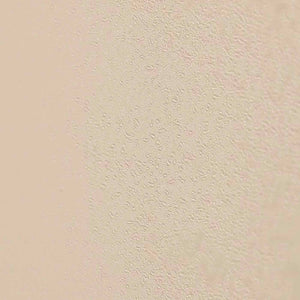 Close-up of a smooth beige surface with fine water droplets, illustrating hydration inspired by Jasmine Tuberose HYDRATING MIST | Sparitual skincare.