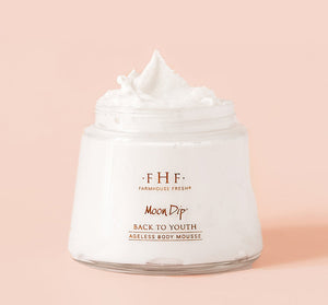 Jar of Moon Dip Back To Youth Ageless Body Mousse | Farmhouse Fresh with whipped white mousse against a soft pink background, highlighting skincare and body care product.
