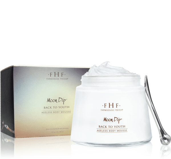 Moon Dip Back To Youth Ageless Body Mousse | Farmhouse Fresh in a clear glass jar with white body mousse and a silver applicator spoon beside the product box, showcasing skincare and body care luxury.