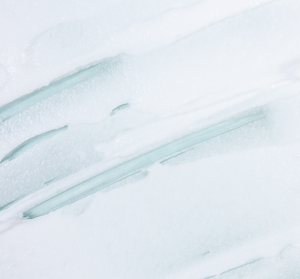 Close-up texture of refreshing exfoliating face polish cream with fine microbeads gently spread, showcasing the smooth and renewing skincare formula of Timescape™ Micromazing™ 2-Minute Renewing Face Polish | Farmhouse Fresh.