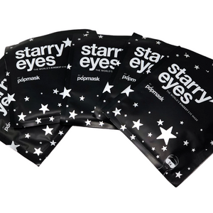Four black foil packets of Starry Eyes Warming Eye Mask - Single | Popmask featuring white star designs and bold white text, promoting skincare and wellness.