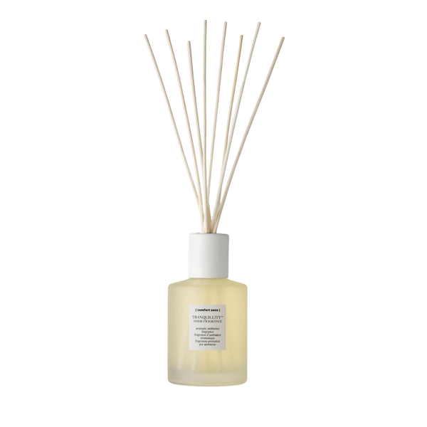 Minimalist reed diffuser with light yellow liquid in frosted glass bottle, styled for calming ambiance and wellness, Tranquillity Home Fragrance | [ comfort zone ].