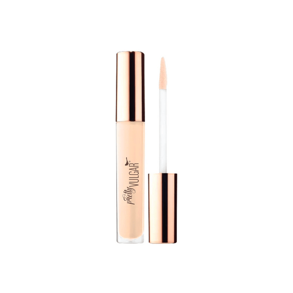 Under Cover Concealer | Pretty Vulgar in a light beige shade with a rose gold cap and applicator wand, designed for flawless skin coverage and a natural finish.